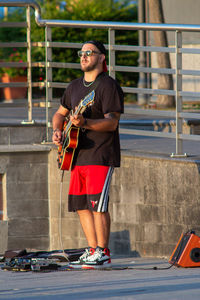 Full length of man playing guitar