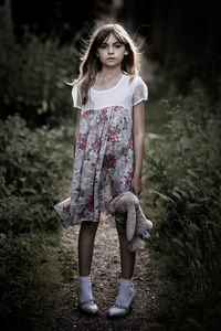 Portrait of a girl standing on field