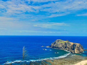 Scenic view of sea against blue sky