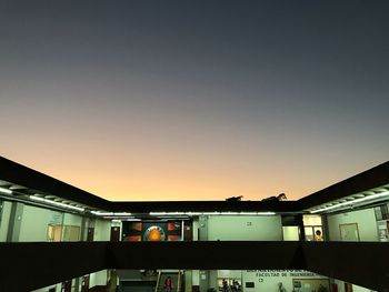 Low angle view of buildings against sky at sunset