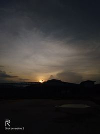 Scenic view of silhouette mountains against sky at sunset