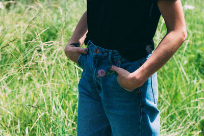 Midsection of woman standing on field