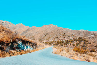 Scenic view of mountains against clear blue sky