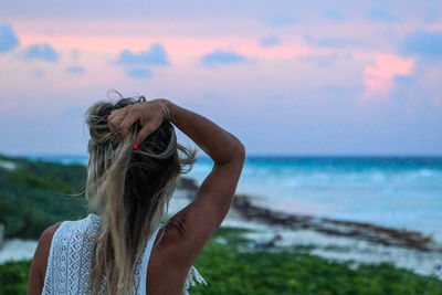 Rear view of woman with sea in background