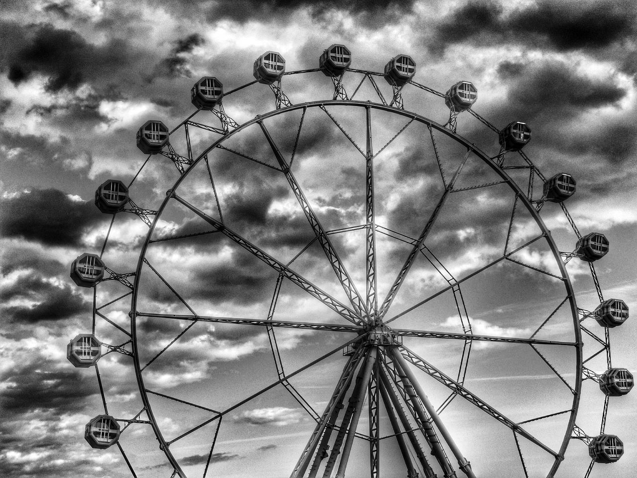 low angle view, sky, amusement park, cloud - sky, amusement park ride, ferris wheel, arts culture and entertainment, cloudy, cloud, weather, built structure, fun, day, overcast, metal, outdoors, enjoyment, no people, dusk, silhouette