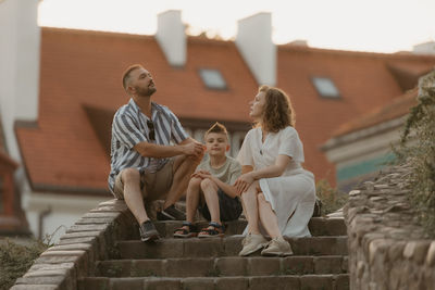 Side view of woman sitting on steps