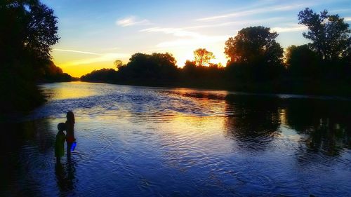 Scenic view of lake at sunset