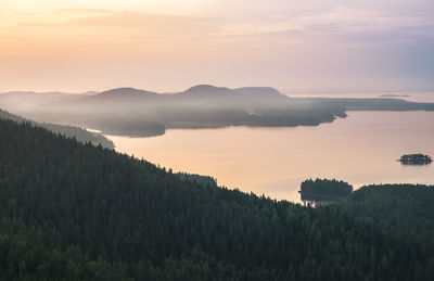 Scenic view of silhouette mountains against sky at sunset