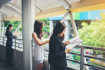 Businesswomen standing on footbridge