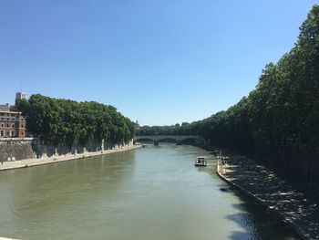 Scenic view of river against clear blue sky