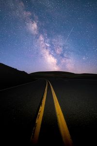 Scenic view of road against sky at night