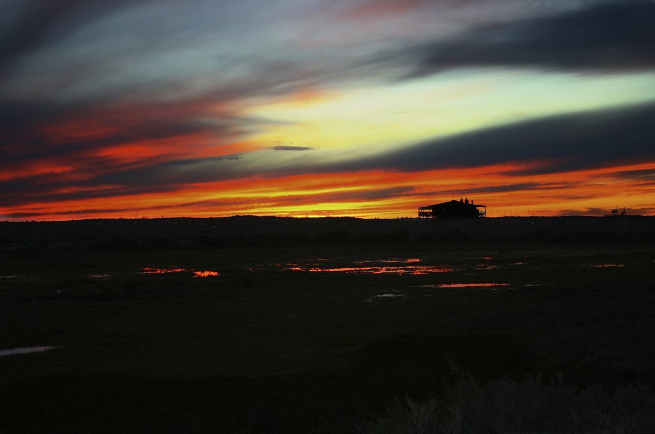 sunset, orange color, sky, scenics, silhouette, beauty in nature, tranquil scene, cloud - sky, dramatic sky, tranquility, transportation, idyllic, nature, road, water, landscape, dusk, cloud, moody sky, outdoors