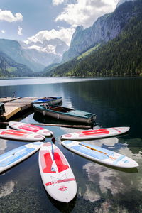 View of boats moored in lake against mountains