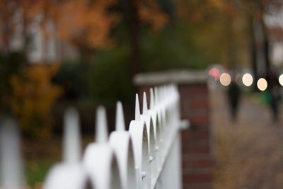 Close-up of white fence in cemetery