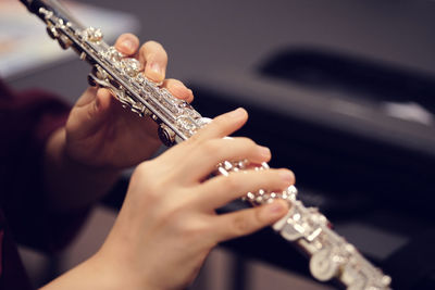 Cropped image of hands holding flute