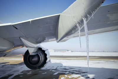 Airplane on runway against sky