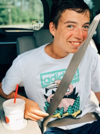 Portrait of young man sitting on seat