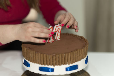 Midsection of woman holding gingerbread cookies