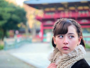 Portrait of young woman in city