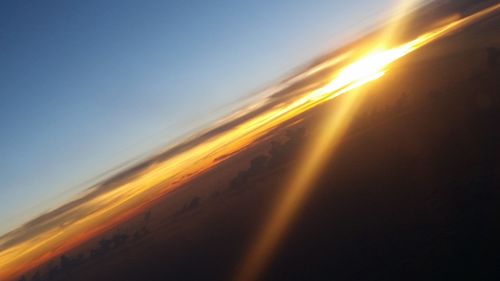 Blurred motion of train against sky during sunset