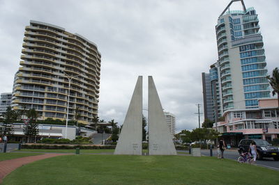 View of skyscrapers against cloudy sky