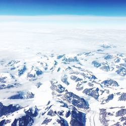 Aerial view of snow covered mountains against sky