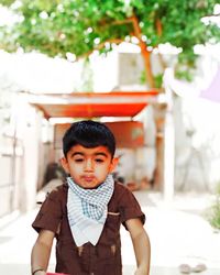 Portrait of cute boy standing outdoors