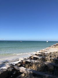 Scenic view of sea against clear blue sky