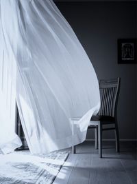 Empty chair against wall at home