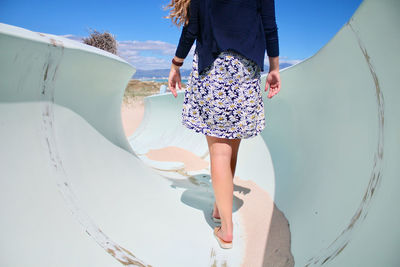 Low section of woman on boat at beach