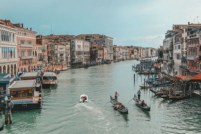 Boats in canal along buildings