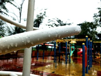 Close-up of water drops on railing