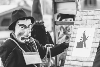 Ancient carnival of sauris. traditional wooden masks. black and white. italy