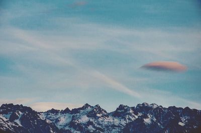 Scenic view of snow covered mountains against sky