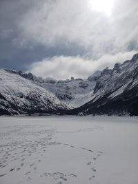 Scenic view of snow covered mountains against sky