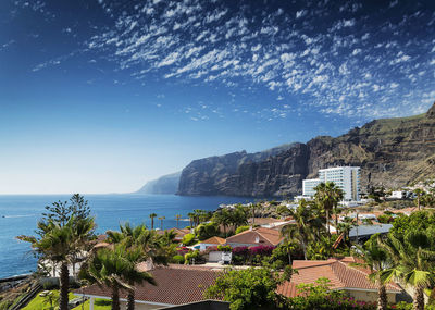 Scenic view of sea and buildings against sky