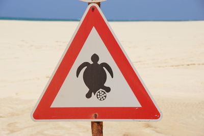 Close-up of turtle nest sign at beach