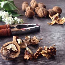Close-up of walnut and nutcracker on table