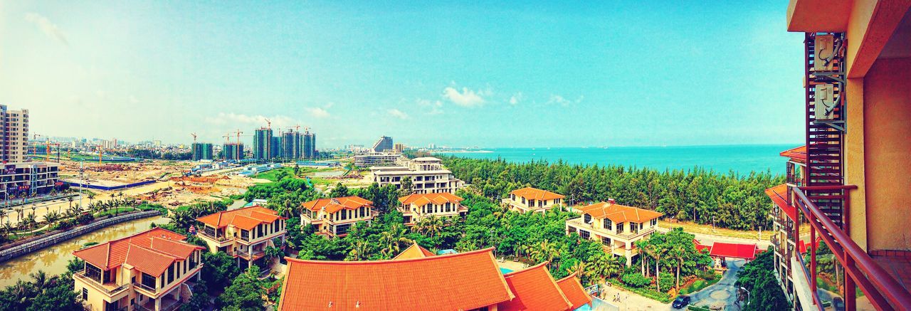 architecture, built structure, building exterior, sea, horizon over water, high angle view, sky, blue, residential district, residential structure, roof, water, residential building, house, city, cityscape, town, panoramic, outdoors, day