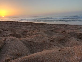 Scenic view of beach against sky during sunset