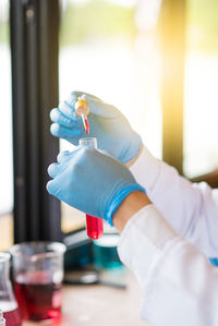 Cropped hands of doctor holding chemical in test tube