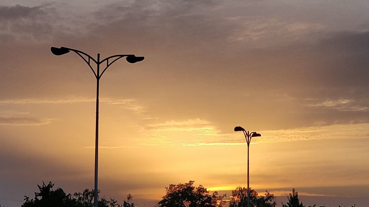 street light, sky, sunset, dawn, cloud, street, lighting equipment, silhouette, nature, tree, evening, horizon, afterglow, no people, beauty in nature, sun, plant, outdoors, orange color, scenics - nature, tranquility, wind, sunlight, dramatic sky, lighting, environment, light fixture, city