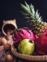 Close-up of fruits in basket on table