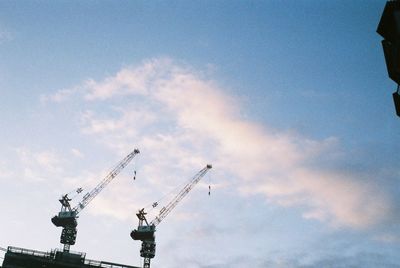 Low angle view of crane against sky