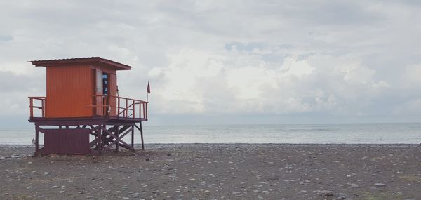 Lifeguard hut on beach against sky