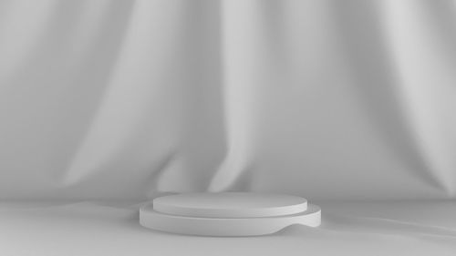 Close-up of white table against wall