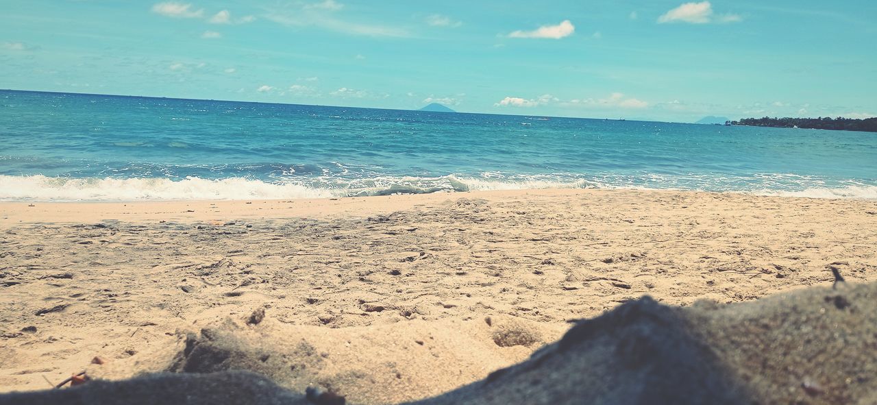 SCENIC VIEW OF SEA SHORE AGAINST SKY