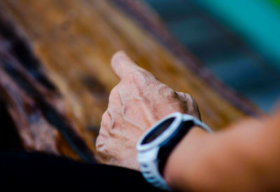 Close-up of person hand wearing wristwatch