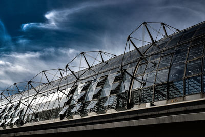 Low angle view of building against cloudy sky