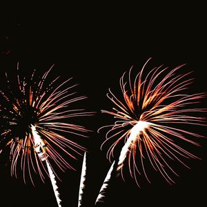 Low angle view of firework display at night